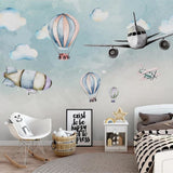 Kids bedroom transformed with airplane and hot air balloon wallpaper, creating a playful atmosphere