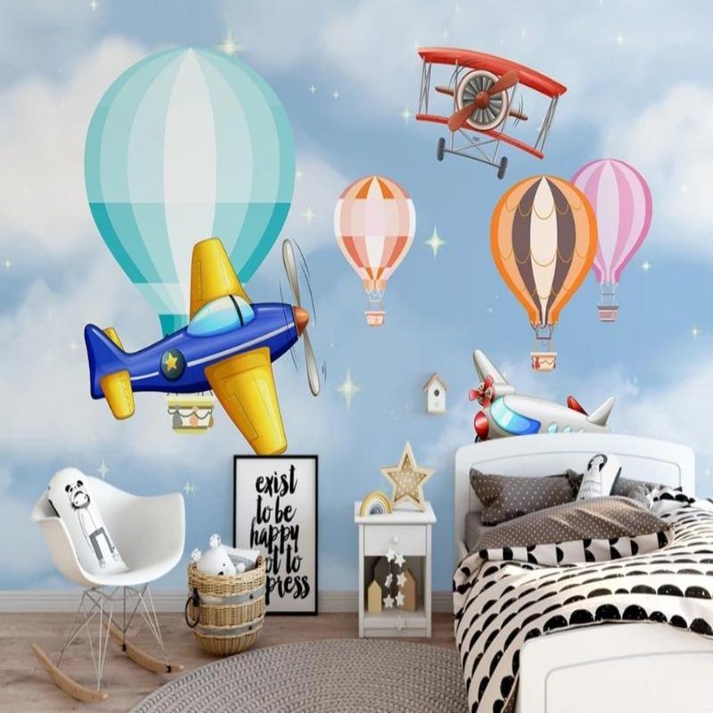 Aviation themed wallpaper in bright nursery with white furniture showing planes and balloons floating above crib