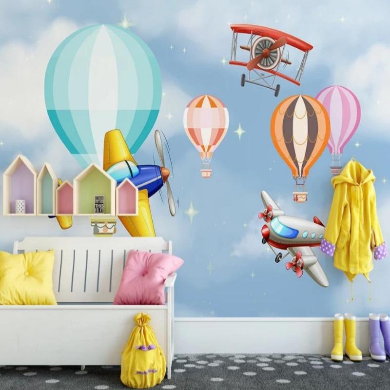 Airplane nursery wallpaper creating magical atmosphere in toddler bedroom with wooden bed