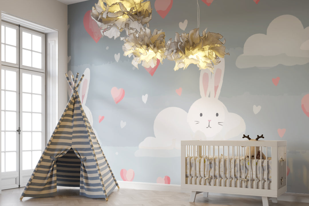 Nursery accent wall with bunny pattern wallpaper beside white dresser and mirror