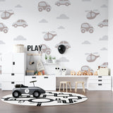 Vehicle wallpaper brightening toddler's bedroom with wooden furniture and toys