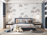Vehicle pattern wallpaper in baby boy nursery with white furniture and mobile