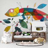 Colorful geometric chameleon wallpaper brightening a modern kids bedroom with white furniture and playful accessories