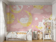 Magical cat and moon wallpaper creating a cozy atmosphere in a modern nursery with soft pink walls and white furniture