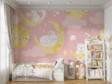 Magical cat and moon wallpaper creating a cozy atmosphere in a modern nursery with soft pink walls and white furniture
