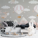 Dreamy balloon wallpaper in baby girl nursery with grey crib