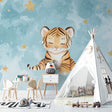 Tiger wallpaper mural shown in cozy nursery with rocking chair and soft lighting