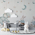 Nursery wallpaper with elephant and bunnies in a cozy modern nursery with white furniture and soft lighting