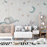 Kids room with starry night animal wallpaper creating a magical reading nook with plush chair