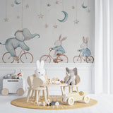 Baby room featuring elephant and bunny wallpaper with neutral decor and wooden crib