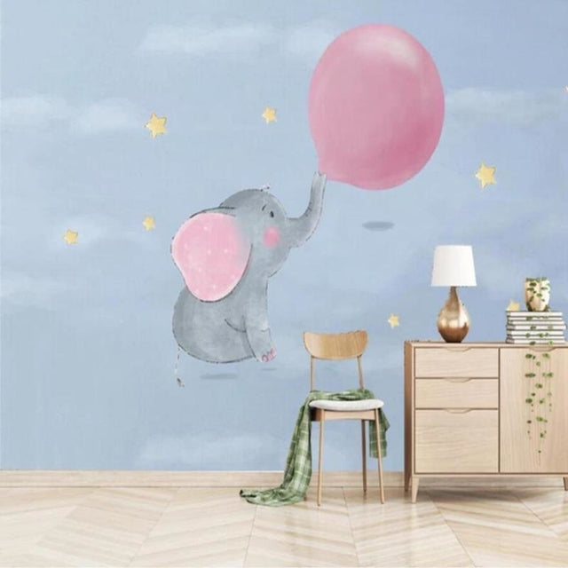 Elephant nursery wallpaper with pink balloon creating a cozy atmosphere in a modern white nursery with wooden furniture