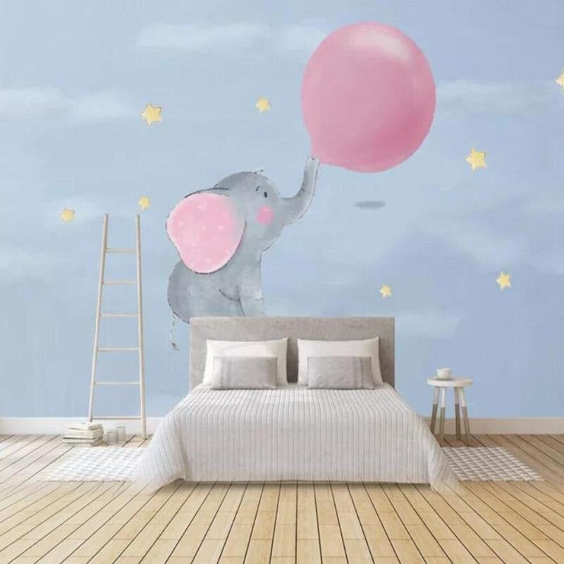 Baby elephant wall mural bringing charm to a toddler's bedroom with soft pink accents and natural lighting