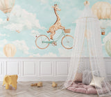 Kids bedroom with playful giraffe and balloon wallpaper next to a reading nook