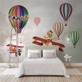 Kids aviation wallpaper with hot air balloons creating a magical atmosphere in a modern nursery