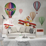 Hot air balloon wallpaper bringing adventure to a bright playroom setting