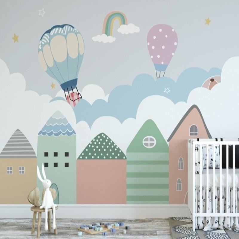 Rainbow and hot air balloon wall mural creating magic in playroom with reading nook