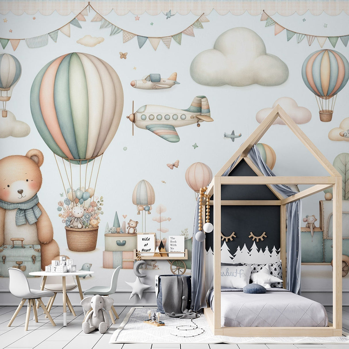 Hot air balloon nursery wallpaper in soft pastels shown in a bright children's bedroom with white furniture and natural light