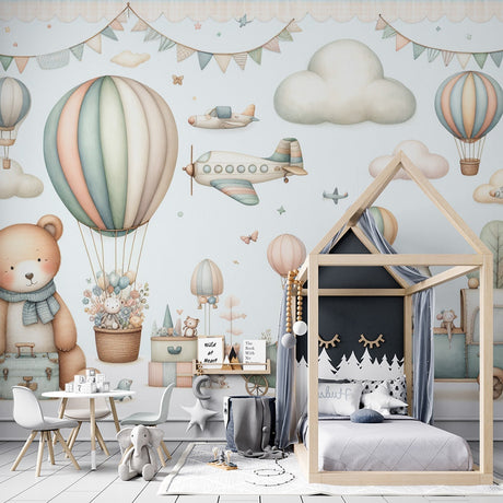 Hot air balloon nursery wallpaper in soft pastels shown in a bright children's bedroom with white furniture and natural light