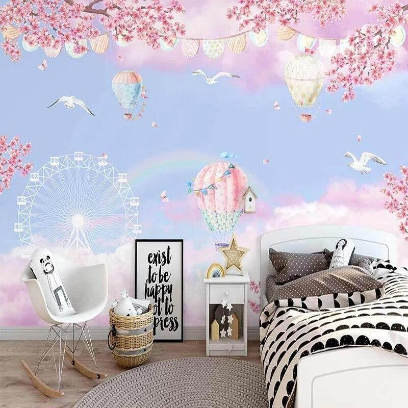 Hot air balloon wallpaper with cherry blossoms creating a magical atmosphere in a bright nursery room