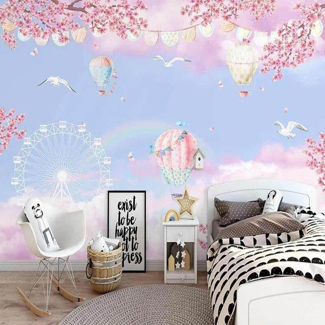 Hot air balloon wallpaper with cherry blossoms creating a magical atmosphere in a bright nursery room