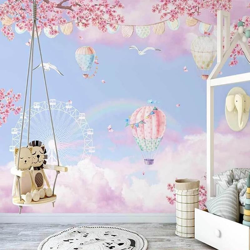 Kids bedroom featuring pink and blue hot air balloon wall mural with floating cherry blossoms