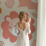 Reading nook with gentle lion wallpaper creating cozy corner