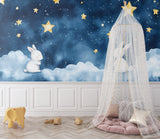 Night sky bunny mural in a playroom with soft lighting and comfortable seating