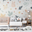Sweet animal nursery wallpaper creating a cozy atmosphere in a modern white nursery with natural wood furniture