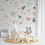Animal and stars nursery wallpaper creating magic in a baby girl's room with pink accents