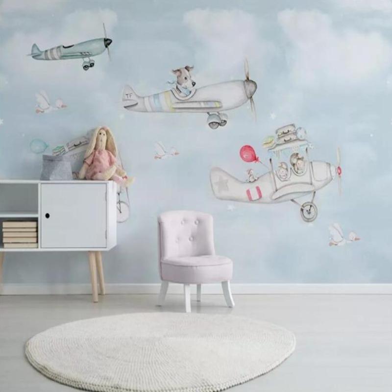 Kids bedroom with flying animals wall mural, showing playful aircraft and animal characters above a cozy reading nook
