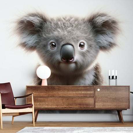 Koala wall mural creating a peaceful atmosphere in a modern nursery with white furniture and natural wood accents
