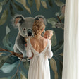 Koala wallpaper in modern nursery with natural wood furniture and soft lighting