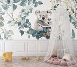 Koala wallpaper mural in a serene nursery setting with natural light and wooden furniture