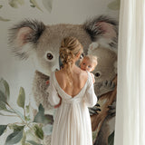 Mother and baby koala wallpaper in a gender-neutral nursery setting