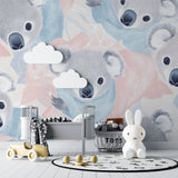 Koala nursery wallpaper in modern white nursery with wooden crib and rocking chair