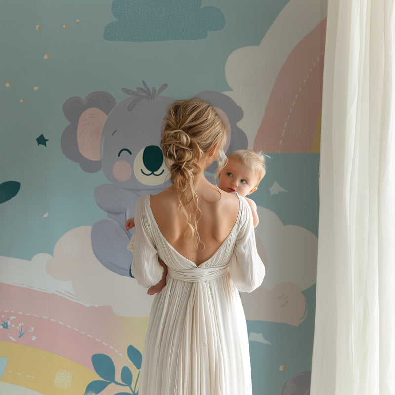 Koala nursery wallpaper with pastel rainbow design styled in a modern white nursery with natural wood furniture