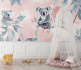 Pink koala wall mural brightening a toddler's reading nook with soft cushions