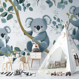Nursery koala wallpaper styled with natural wood furniture and soft textiles