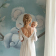 Koala wallpaper in a modern nursery with white furniture, creating a peaceful sleep environment