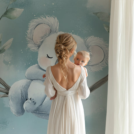 Koala wallpaper in a modern nursery with white furniture, creating a peaceful sleep environment