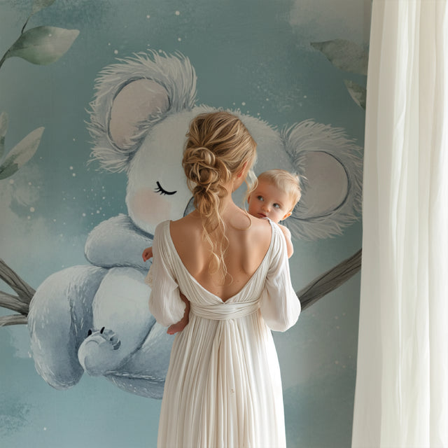 Koala wallpaper in a modern nursery with white furniture, creating a peaceful sleep environment