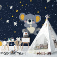 Koala nursery wallpaper in a modern baby room with soft lighting and wooden furniture