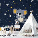 Koala nursery wallpaper in a modern baby room with soft lighting and wooden furniture
