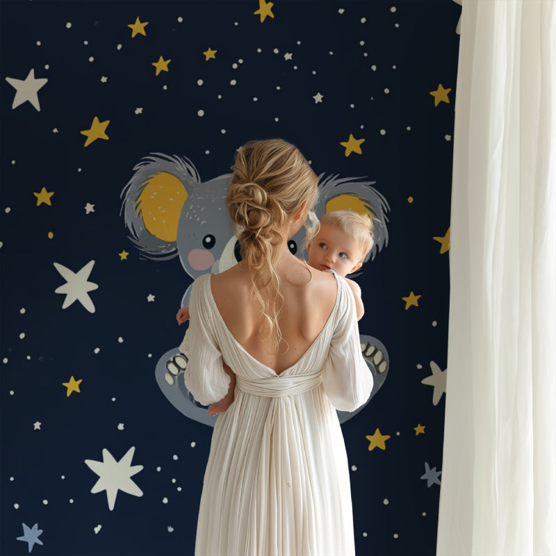 Starry koala wall mural creating a cozy reading nook in a toddler's bedroom
