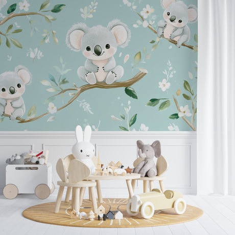 Koala nursery wallpaper in a bright modern nursery with white furniture showing sweet sleeping koalas on branches