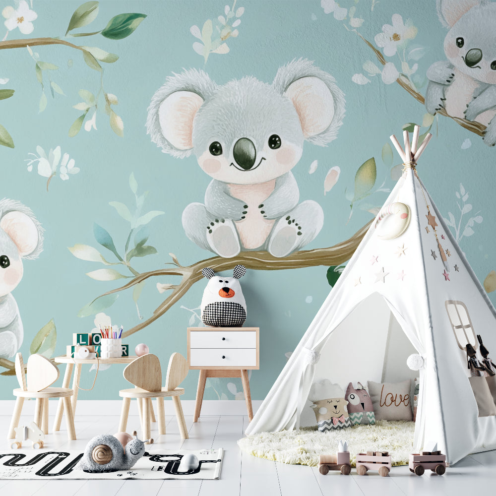 Baby room with koala wall mural featuring mint green background and white blossoms above changing table