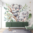 Koala family wallpaper creates a peaceful atmosphere in a soft-toned nursery with natural light