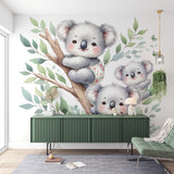 Koala family wallpaper creates a peaceful atmosphere in a soft-toned nursery with natural light