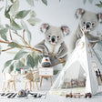 Koala wallpaper mural creating a cozy atmosphere in a modern nursery with natural light