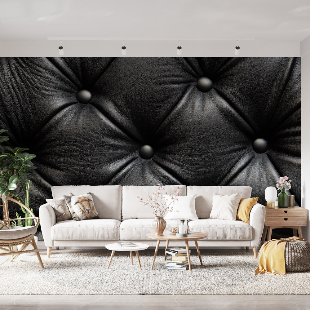 Black leather tufted wallpaper creating luxurious atmosphere in modern living room with grey sofa and pendant lighting